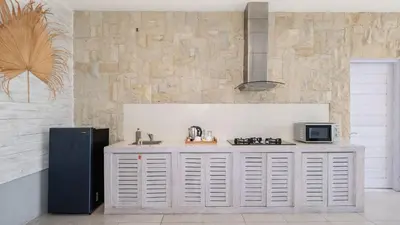 a kitchen with a sink and a refrigerator at Villa Larimar by Villa Finder in Legian