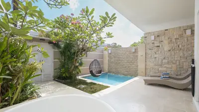 a swimming pool in the backyard of a house at Villa Larimar by Villa Finder in Legian