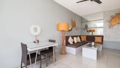 a living room with a couch and a table at Villa Larimar by Villa Finder in Legian