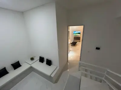 a white room with two pillows on a white wall at Klissy Studio Villa in Kerobokan