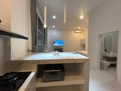 a kitchen with a marble counter top in a room at Klissy Studio Villa in Kerobokan