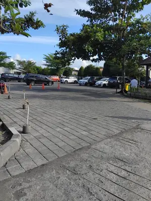a parking lot with cars parked in a parking lot at Cozy Apartement in Seminyak in Uluwatu