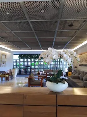 a lobby with a vase of flowers on a table at Cozy Apartement in Seminyak in Uluwatu