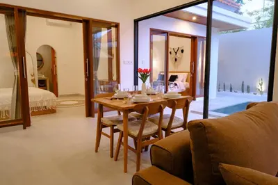a dining room with a table and chairs and a bedroom at New Vindra II Villa Mediteranian 2BR Canggu in Canggu