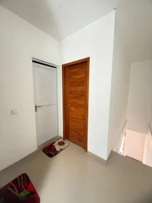 an empty room with a door and a dog bed at Home Stay Room in Bali Near Sanur Beach in Sanur