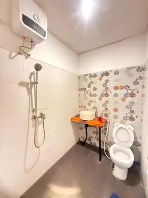 a bathroom with a shower and a toilet at Home Stay Room in Bali Near Sanur Beach in Sanur