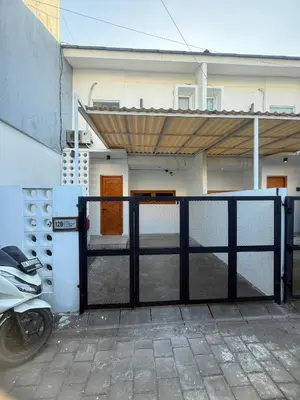 a gate in front of a house with a motorcycle at Home Stay Room in Bali Near Sanur Beach in Sanur