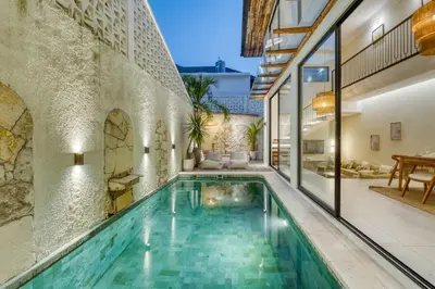 an indoor swimming pool in a home with a house at Casa Amadeo Villas Seminyak in Seminyak
