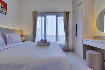 a bedroom with a white bed with a teddy bear on it at Stylish 2BR Villa Taman Seminyak 52 near Beach in Seminyak