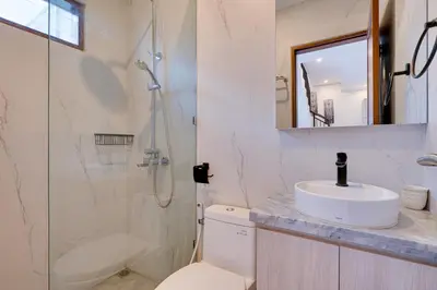 a bathroom with a toilet and a shower and a sink at Stylish 2BR Villa Taman Seminyak 52 near Beach in Seminyak