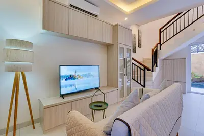a living room with a couch and a flat screen tv at Stylish 2BR Villa Taman Seminyak 52 near Beach in Seminyak