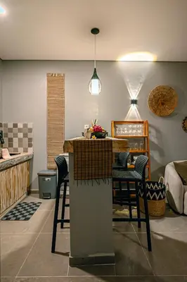 a kitchen with a table and chairs in a room at Amshiga 1 in Jimbaran