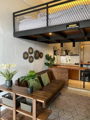 a living room with a couch and a table at Odua Mezzanine - Bromo in Denpasar
