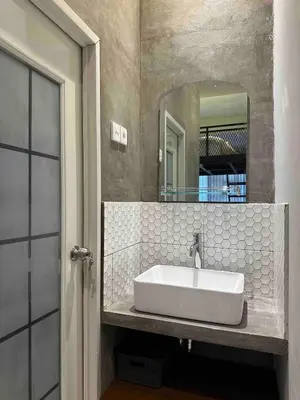 a bathroom with a sink and a mirror at Odua Mezzanine - Bromo in Denpasar