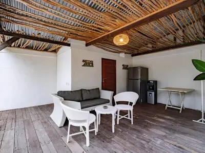 a living room with a couch and chairs and a table at Villa Melissa in Kerobokan