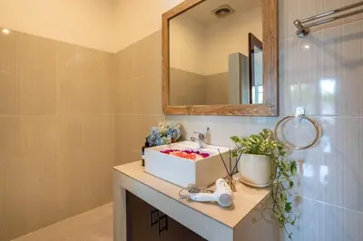 a bathroom with a sink and a mirror at Arts Heliconia Villa Two-Bedroom Private Pool Kuta in Kerobokan
