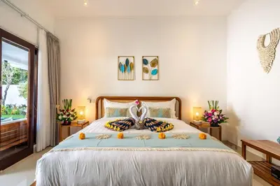a bedroom with a large bed with oranges on it at Arts Heliconia Villa Two-Bedroom Private Pool Kuta in Kerobokan