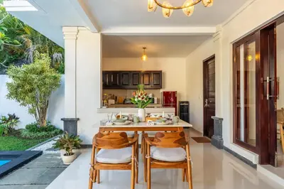 a kitchen and dining room with a table and chairs at Arts Heliconia Villa Two-Bedroom Private Pool Kuta in Kerobokan