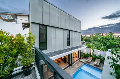 an aerial view of a house with a swimming pool at Divija Villa by Unicorn Villas Bali in Kerobokan