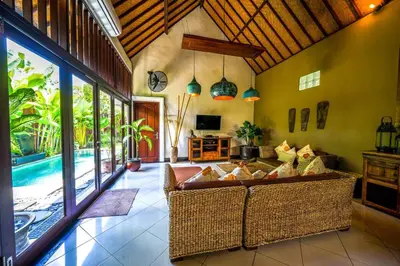 a living room with a couch and a pool at Villa ABBI Luxury 2 Bedroom Villa - Legian Seminyak in Seminyak