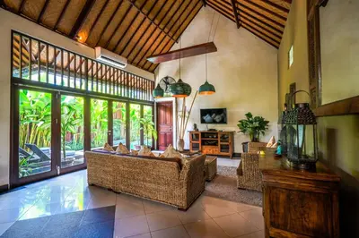 a living room with couches and a large window at Villa ABBI Luxury 2 Bedroom Villa - Legian Seminyak in Seminyak