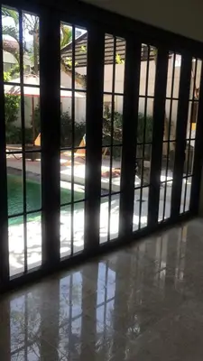 an open door to a building with a view of a yard at Shivana Villa in Kerobokan