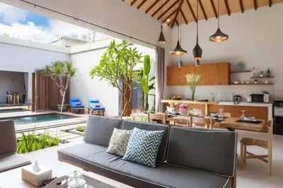 an outdoor living room with a couch and a table at Modern Tropical 2BR Villa in Seminyak Kuta with Pool & Garden in Legian