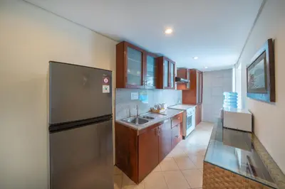 a kitchen with a stainless steel refrigerator and a sink at The Cemara Umalas in Kerobokan