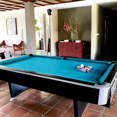 a pool table in a living room at Abia Villa Legian in Legian
