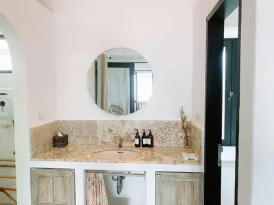 a bathroom with a sink and a mirror at Lovely 2 Bedroom Pool Villa Close to The Beach in Seminyak