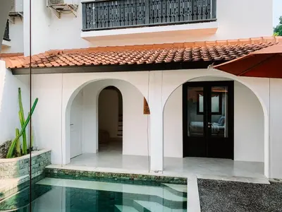 a house with a pool in front of it at Lovely 2 Bedroom Pool Villa Close to The Beach in Seminyak