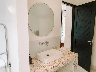 a bathroom with a sink and a mirror at Lovely 2 Bedroom Pool Villa Close to The Beach in Seminyak
