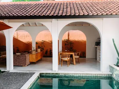 a house with a swimming pool in front of a house at Lovely 2 Bedroom Pool Villa Close to The Beach in Seminyak