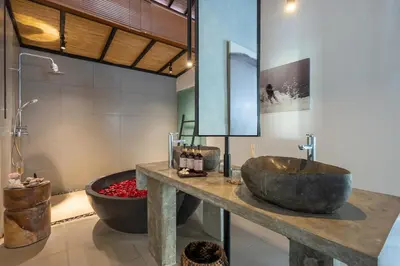 a bathroom with a large sink and a tub at Semesta Collection Seminyak Villas in Seminyak