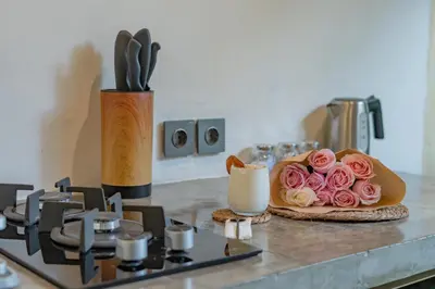 a counter with a plate with pink roses on it at Semesta Collection Seminyak Villas in Seminyak