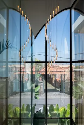 a room with a large glass window with chandeliers at Villa Amare in Kerobokan