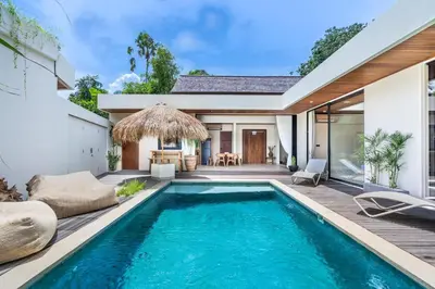 a swimming pool in the backyard of a house at Kin House Bali in Seminyak