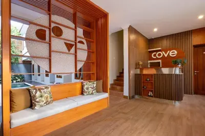 a living room with a bench and a love sign at Cove Vin Stay Petanu in Pesanggaran