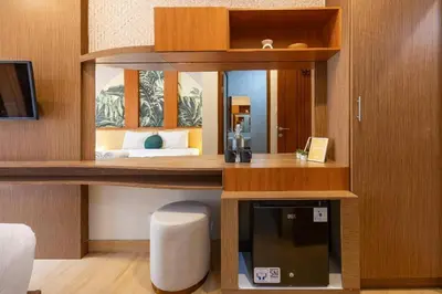 a room with a desk and a mirror and a bed at Cove Vin Stay Petanu in Pesanggaran