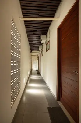 an empty hallway with a door and a hallway sidx sidx sidx at TheNadram Guest House in Kerobokan
