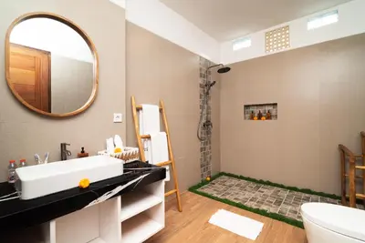 a bathroom with a sink and a mirror at Villa O'Anne 3 in Seminyak