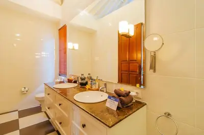 a bathroom with two sinks and a mirror at Private 2 Br Pool Villa, 400m to Beach, Sleeps 4 in Seminyak