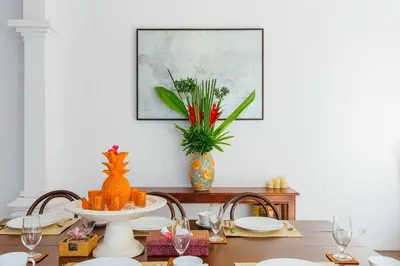 a dining room with a table with a pineapple centerpiece at Private 2 Br Pool Villa, 400m to Beach, Sleeps 4 in Seminyak