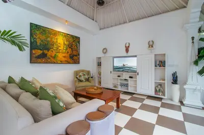 a living room with a couch and a table at Private 2 Br Pool Villa, 400m to Beach, Sleeps 4 in Seminyak