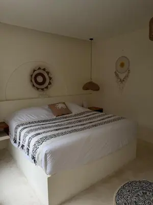 a bedroom with a large white bed in a room at Villa Bambu in Sanur