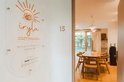a sign on the door of a restaurant with a table at Iryla Villa Bali in Seminyak