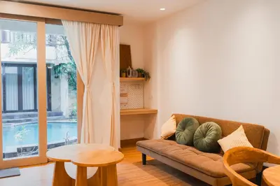 a living room with a couch and a table at Iryla Villa Bali in Seminyak