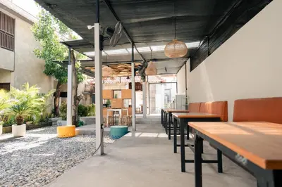 a row of tables and chairs in a restaurant at Kuta Sekeca CoWorking Apartment Close to Kuta Beach in Jimbaran