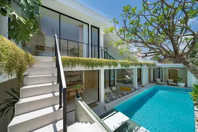 an external view of a house with a swimming pool at Kona Resort - Seminyak in Kerobokan