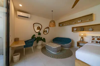 a bedroom with a bed and a desk at Kona Resort - Seminyak in Kerobokan